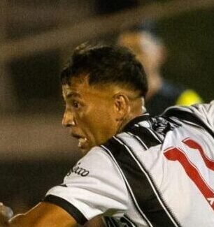 Dynamic moment in a soccer match with players in action during a night game on the field.